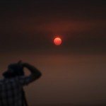 Jason Anderson, 42, Takes Pictures As The Sun Is Visible Through Thick Smoke Generated By The Bobcat Fire In San Dimas, Calif