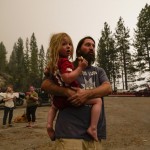 Jeremy Hedrick Holds His Son Jeep As Smoke From The Creek Fire Fills The Air In A Marina, Were Campers Were Being Held Due To Impassable Roads, Caused By The Fire Monday, Sept. 7, 2020
