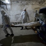 Pathologists In Protective Suits Transport The Body Of A Person Who Died Of The Coronavirus At A Hospital's Morgue In Bishkek, Kyrgyzstan