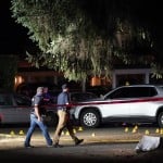 Police Walk Past Evidence Markers At A Scene Thursday, Sept. 3, In Lacey, Wash