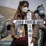 Ruth Morales, 36, Center, Waits For The Arrival Of The Coffin Of Her Husband, Juan Paucar Quispe, 63, Who Died From Covid 19 Complications, During His Burial At A Cemetery In Carabayllo, Lima, Peru
