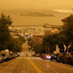 Under Darkened Skies From Wildfire Smoke, A Man Crosses Hyde Street With Alcatraz Island And Fisherman's Wharf In The Background Wednesday, Sept. 9