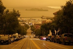 Under Darkened Skies From Wildfire Smoke, A Man Crosses Hyde Street With Alcatraz Island And Fisherman's Wharf In The Background Wednesday, Sept. 9