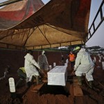 Workers Lower A Coffin Containing The Body Of A Suspected Covid 19 Victim Into A Grave During A Burial At The Special Section Of Pondok Ranggon