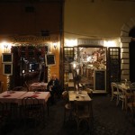 A Man Sits Outside An Empty Restaurant In Rome's Trastevere Neighborhood, Friday, Oct. 23