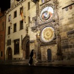 A Nun Walks Past The Astronomical Clock On A Near Empty Old Town Square In Prague, Czech Republic, Friday, Oct. 23