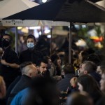 A Waiter And Waitress Wearing Masks Serve Their Customers In The Pedestrianized Part Of Old Compton Street In London, Friday, Oct. 23