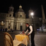 A Waiter Clears A Table At A Cafe Restaurant In Piazza Navona Square Before The Start Of A Curfew, Friday, Oct. 23,