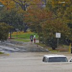 A vehicle is submerged in floodwater on Freedom Drive in Charlotte