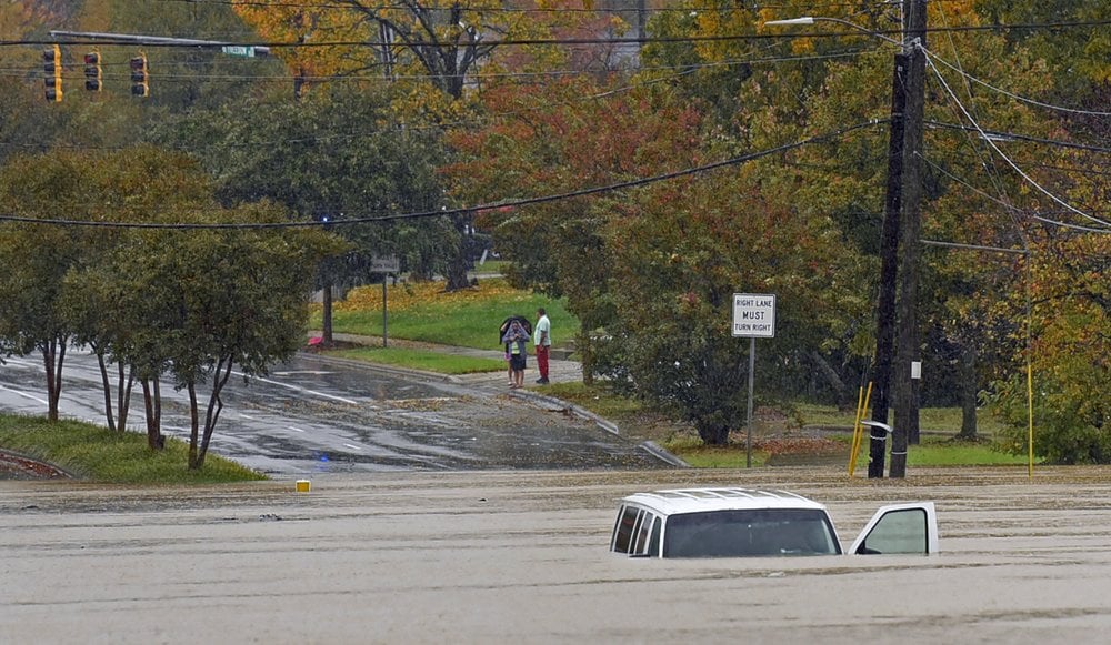 A vehicle is submerged in floodwater on Freedom Drive in Charlotte