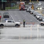 Traffic is rerouted to avoid the flooded Sugar Creek across W. Arrowood Road in Charlotte