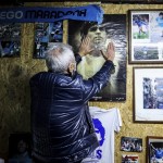 A Man Touches A Poster Of Soccer Legend Diego Maradona, In Naples, Italy, Wednesday, Nov. 25, 2020