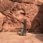 Utah State Worker Inspecting A Metal Monolith That Was Found Installed In The Ground In A Remote Area Of Red Rock In Utah Ap 02
