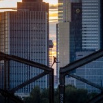 A Parkour Runner Jumps On A Railway Bridge With The Buildings Of The Banking District In Background In Frankfurt, Germany, On Sept. 9, 2020