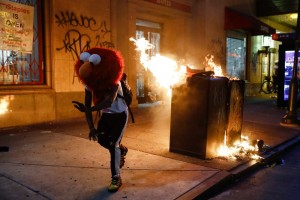 A Protester In An Elmo Mask Dances As A Street Fire Burns On May 30, 2020