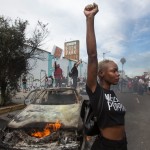 A Protester Poses For Photos Next To A Burning Police Vehicle In Los Angeles On May 30, 2020, During A Demonstration Over The Death Of George Floyd