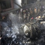 Rescue Workers And Local Residents Search For Survivors In The Wreckage Of A Plane That Crashed With Nearly 100 People Onboard In A Residential Area Of Karachi, Pakistan