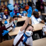 Wearing Masks And Plastic Gloves To Prevent The Spread Of The Coronavirus, Girls Raise Their Hands During Class In Havana, Cuba, On Monday, Nov. 2, 2020