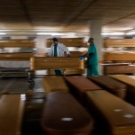 Workers Move A Coffin With The Body Of A Victim Of Covid 19 As Other Coffins Are Stored Waiting For Burial Or Cremation At The Collserola Morgue In Barcelona, Spain