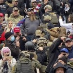 A Line Of Men Wearing Helmets And Olive Drab Body Armor Walk Up The Marble Stairs Outside The U.s. Capitol
