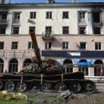 A Destroyed Tank And A Damaged Apartment Building From Heavy Fighting Are Seen In An Area Controlled By Russian Backed Separatist Forces In Mariupol Ukraine