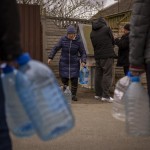 Local Residents Fill Their Bottles With The Water They Draw From A Public Fountain In Bucha