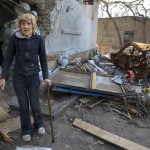 A Local Woman Stands Near A Damaged Apartment Building From Heavy Fighting In An Area Controlled By Russian Backed Separatist Forces In Mariupol Ukraine