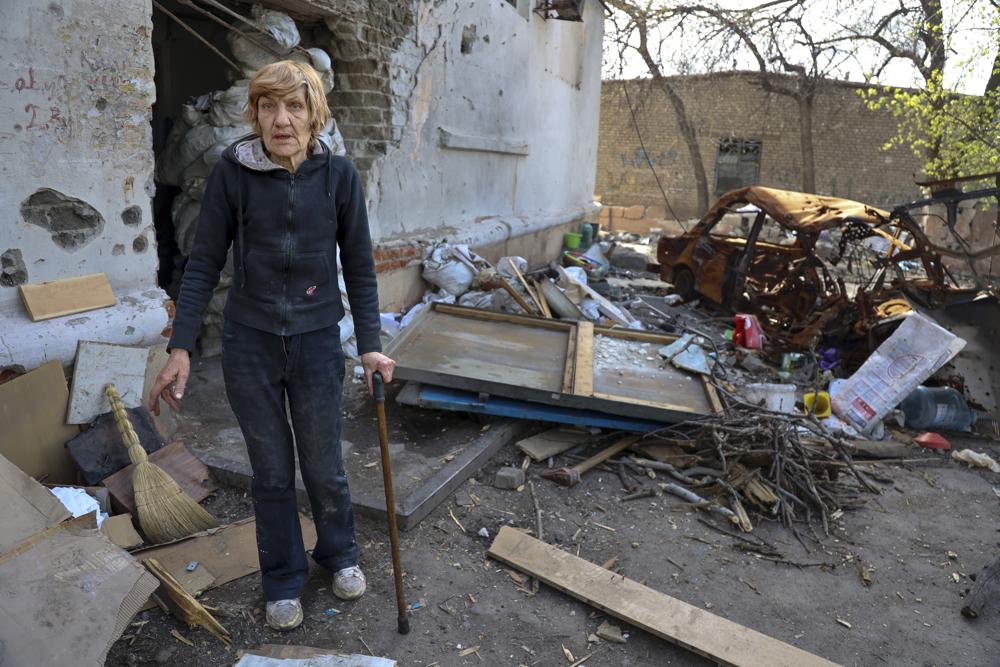 A Local Woman Stands Near A Damaged Apartment Building From Heavy Fighting In An Area Controlled By Russian Backed Separatist Forces In Mariupol Ukraine