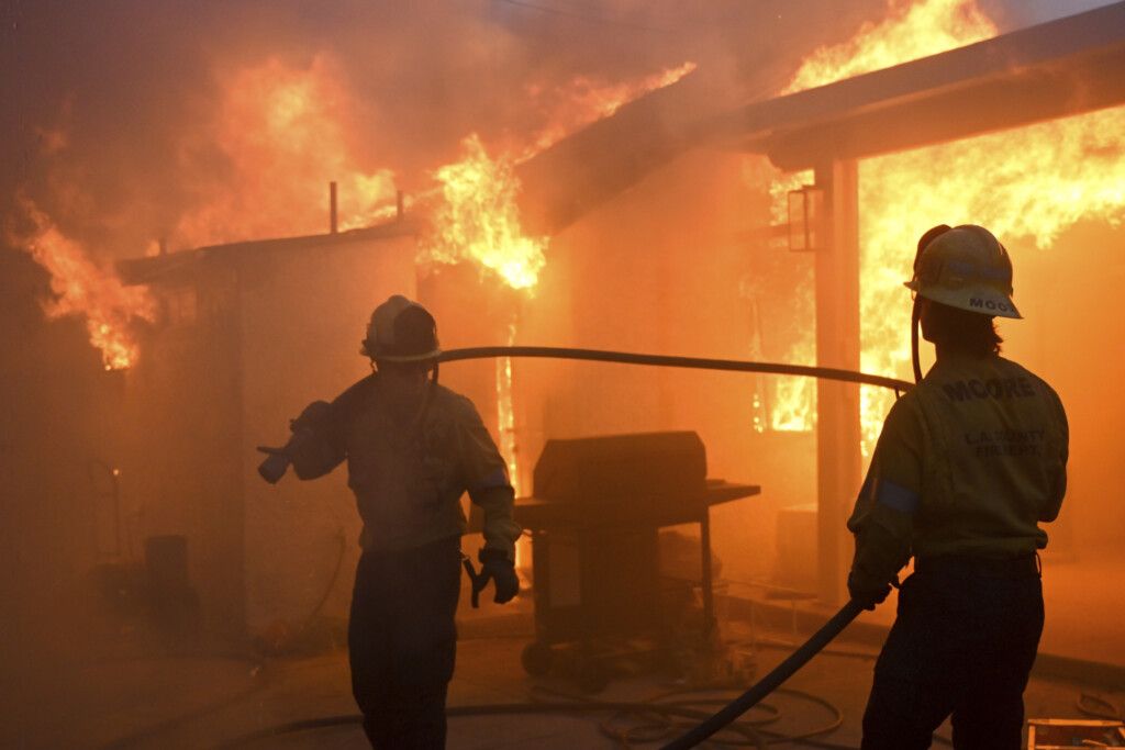 Firefighters battle the Eaton Fire as it engulfs structures Wednesday, Jan. 8, 2025 in Altadena, Calif. (AP Photo/Nic Coury)
