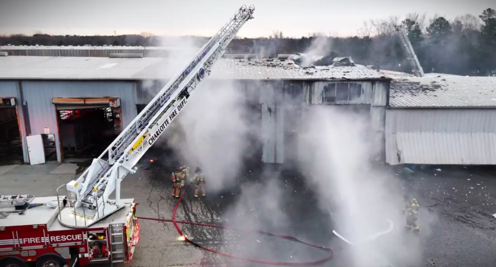 This picture from Charlotte Fire shows crews working to put out a fire at a warehouse in northwest Charlotte on Tuesday.