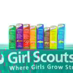 Alameda, Ca February 06, 2019: Traditional Girl Scout Cookie Booth Table With Little Brownie Baker Brand Cookies Isolated On White. Cookie Sales Raise Funds For Troop Lead Events And Activities.