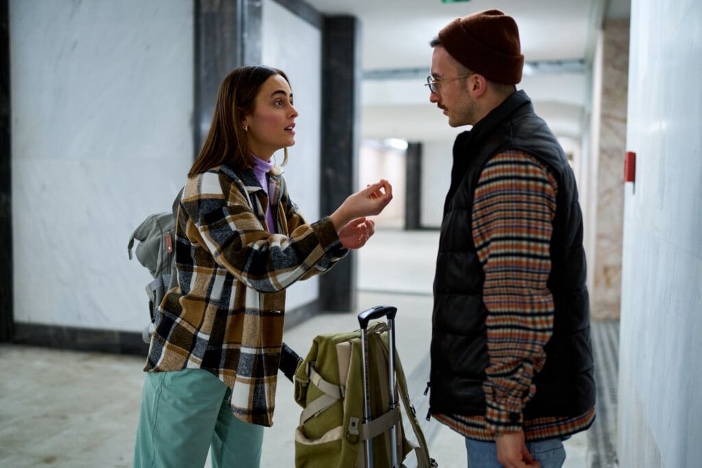 Caucasian Couple In A Heated Debate In The Airport Terminal Hallway, Travel Tension Rising.