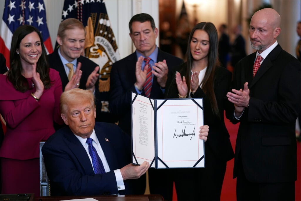 President Donald Trump holds the document after signing the Laken Riley Act during an event in the East Room of the White House, Wednesday, Jan. 29, 2025, in Washington. (AP Photo/Evan Vucci)
