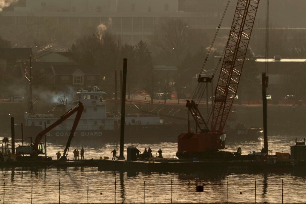 Rescue and salvage crews with cranes work near the wreckage of an American Airlines jet in the Potomac River from Ronald Reagan Washington National Airport, Monday, Feb. 3, 2025, in Arlington, Va. . (AP Photo/Jose Luis Magana)