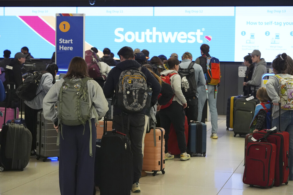 Travelers wait at the check-in counter for Southwest Airlines in Denver International Airport Thursday, Dec. 19, 2024, in Denver. (AP Photo/David Zalubowski, File)