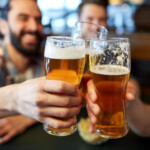 Happy Male Friends Drinking Beer At Bar Or Pub