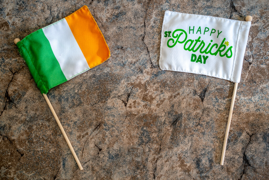 Happy St Patricks Day Flag With An Ireland Flag. Concept For St Patricks Day. Flatlay On Marble Background