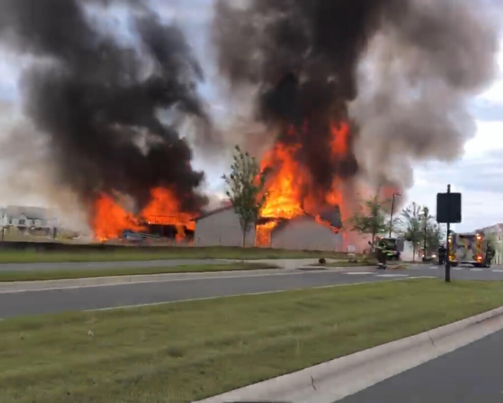 Flames burned a construction site in Harrisburg on Monday.