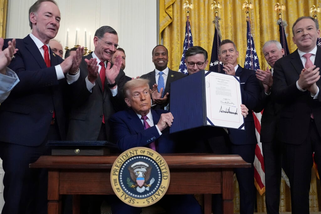 President Donald Trump holds up a signed bill blocking California's rule banning the sale of new gas-powered cars by 2035 in the East Room of the White House, Thursday, June 12, 2025, in Washington. (AP Photo/Evan Vucci)