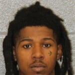 Damien Evans is charged with possession of firearm by felon and possession of stolen firearm following a mass shooting in Uptown.