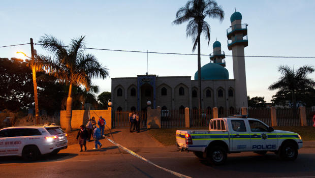 Police investigators collect evidence at a mosque where three men where attacked in Ottawa