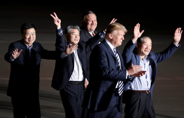 The three Americans formerly held hostage in North Korea gesture next to U.S.President Donald Trump and Secretary of State Mike Pompeo