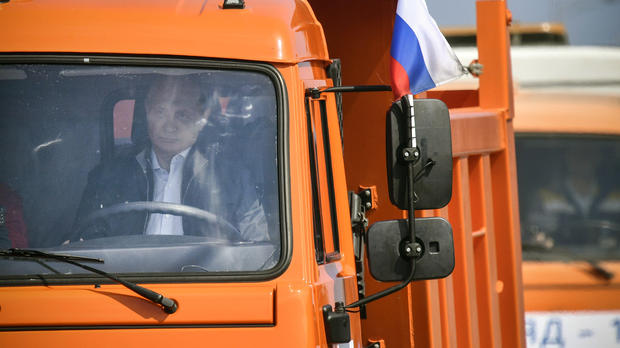 Russian President Vladimir Putin drives a Kamaz truck during a ceremony opening a bridge