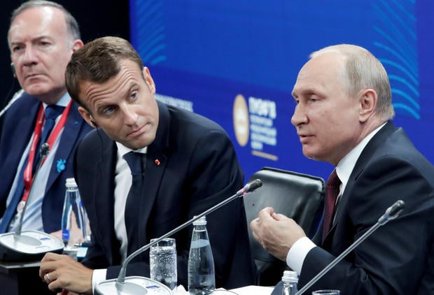 Russian President Vladimir Putin and his French counterpart Emmanuel Macron attend a session of the St. Petersburg International Economic Forum (SPIEF)