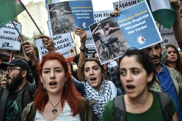 Protestors hold banners reading "Palestinian will win" as they march on Istiklal avenue in Istanbul