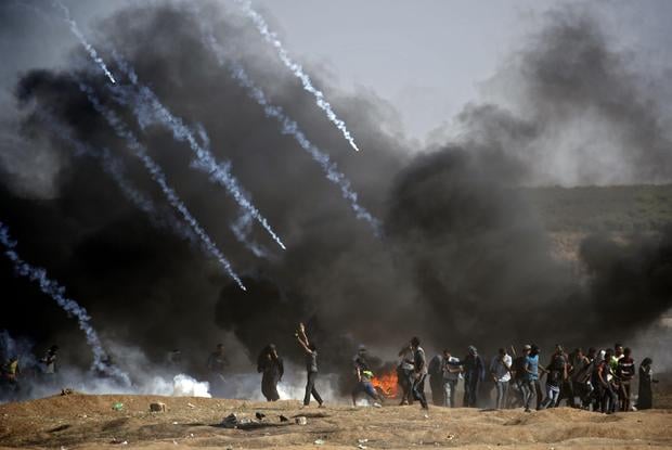 Tear gas is fired at protestors during clashes with Israeli forces near the border between the Gaza strip and Israel