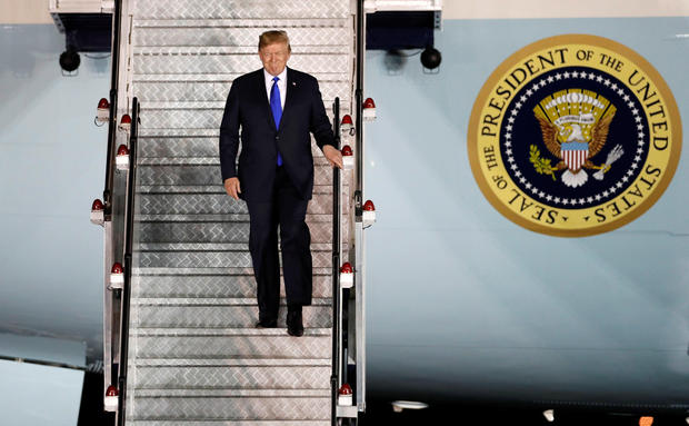 U.S. President Donald Trump steps off his plane as he arrives at Paya Lebar Air Base in Singapore