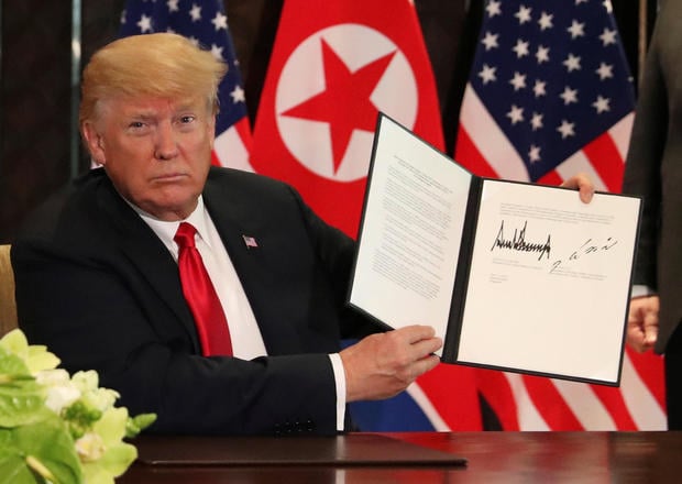 Donald Trump signing U.S.-North Korea summit 