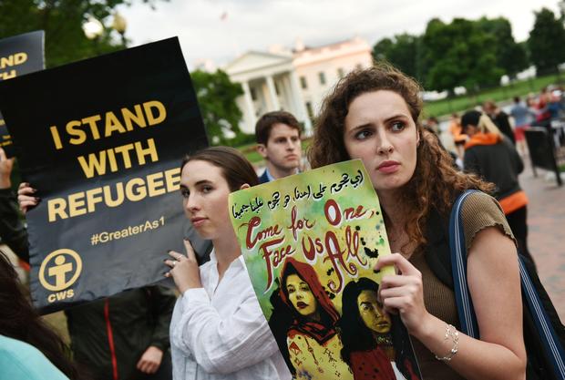 Women hold signs during a rally before iftar