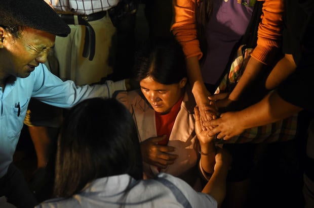 Family members and relatives pray as they keep vigil near the Tham Luang cave in Khun Nam Nang Non Forest Park in Chiang Rai on June 26